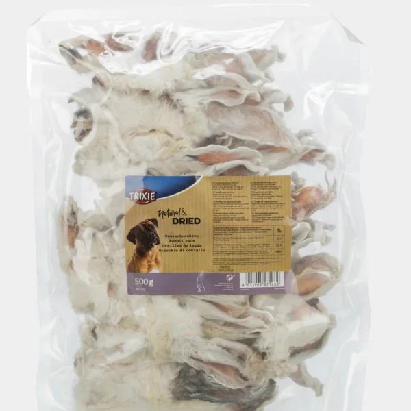 olsa transparente de 500g de golosinas para perros Trixie mostrando orejas de conejo deshidratadas, un snack natural y saludable para la higiene dental canina