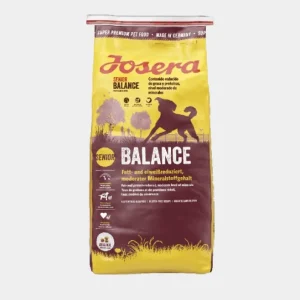 Bolsa de comida seca para perros mayores Josera Senior Balance con contenido reducido de grasas y proteínas, y nivel moderado de minerales, sobre fondo amarillo y marrón con siluetas